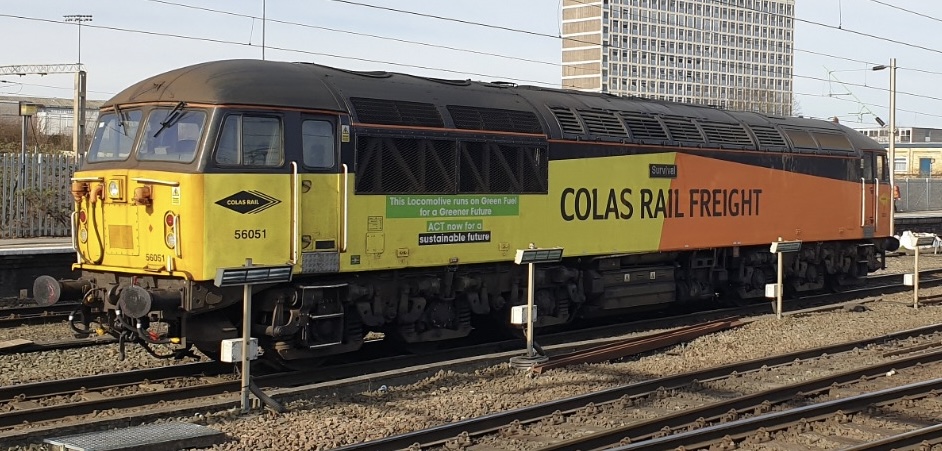 b48e3629-c3bb-422b-8845-5d17d1672ef8 - Midland Railway - Butterley Diesel freight locomotive painted yellow and orange with COLAS RAIL FREIGHT branding at a railway yard.